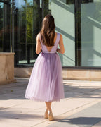 Rochie de ocazie mov deschis midi cu decolteu, șiret reglabil la spate și fustă din tull.